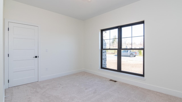 unfurnished room featuring light colored carpet