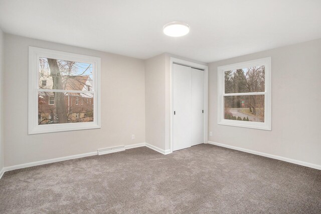 unfurnished bedroom with carpet flooring and a closet