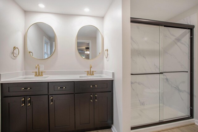 bathroom with an enclosed shower and vanity