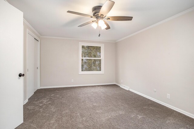 empty room featuring carpet flooring, ceiling fan, and ornamental molding