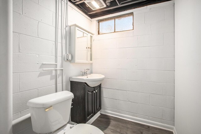 bathroom featuring hardwood / wood-style flooring, vanity, and toilet