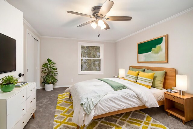 carpeted bedroom featuring ceiling fan and crown molding