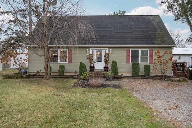 new england style home featuring a front lawn