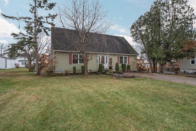 cape cod home featuring a front yard