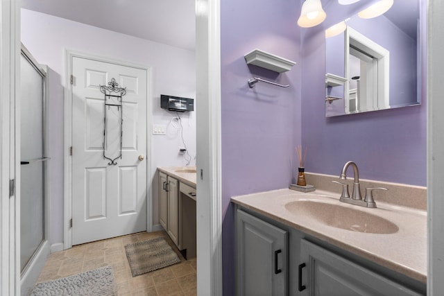 bathroom featuring vanity and an enclosed shower