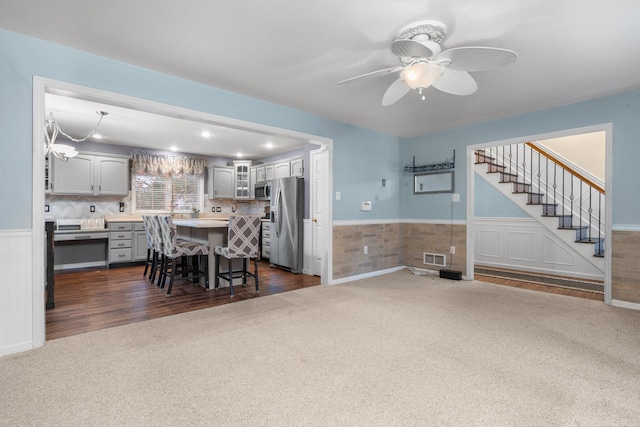 carpeted dining space with ceiling fan