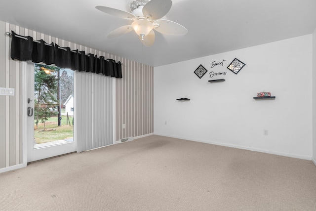 carpeted empty room featuring ceiling fan