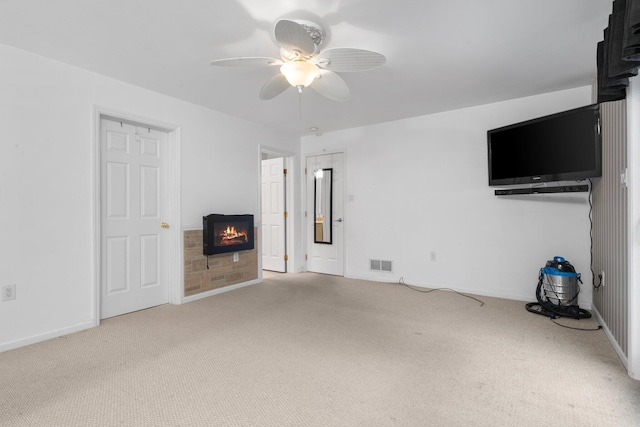 unfurnished living room featuring ceiling fan and light colored carpet