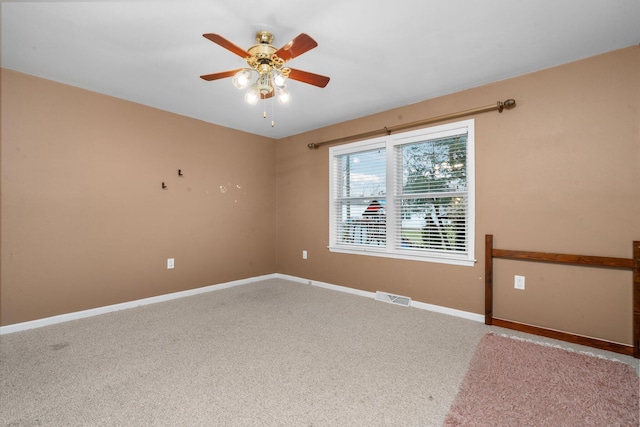 carpeted spare room with ceiling fan