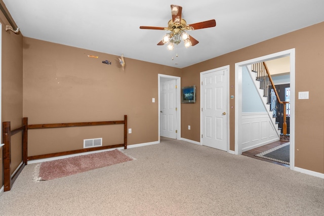 carpeted spare room with ceiling fan