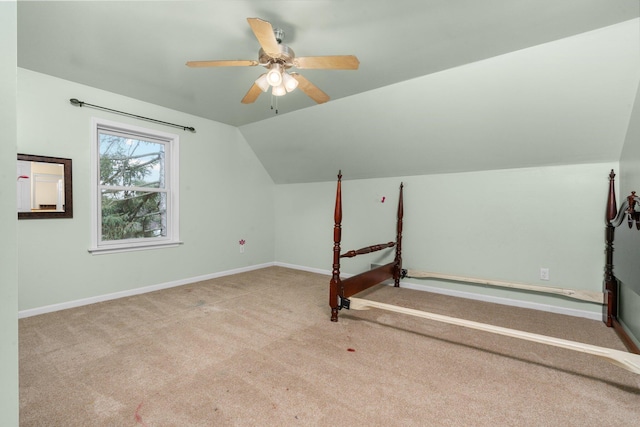 bonus room featuring ceiling fan, light carpet, and vaulted ceiling