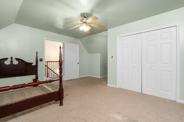 bedroom featuring ceiling fan, lofted ceiling, light carpet, and a closet