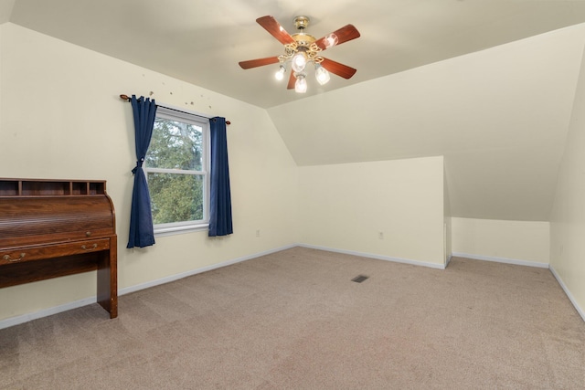 additional living space with ceiling fan, light colored carpet, and lofted ceiling