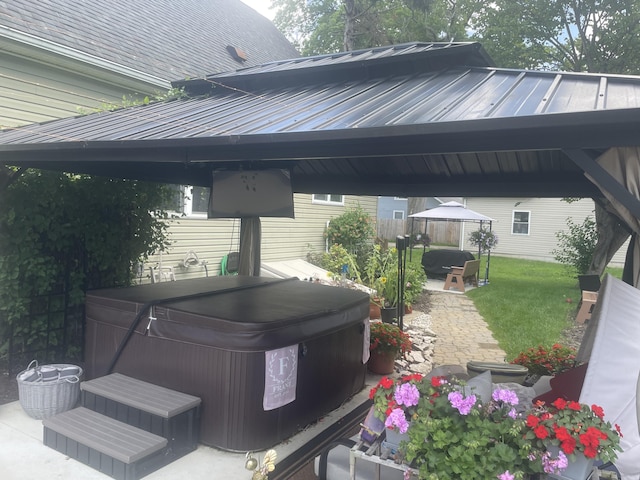 exterior space with a gazebo and a hot tub