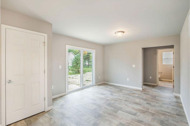 empty room with light hardwood / wood-style floors