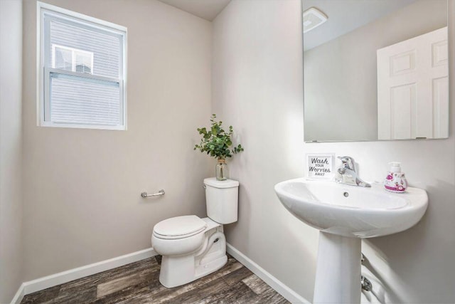 bathroom with toilet and wood-type flooring