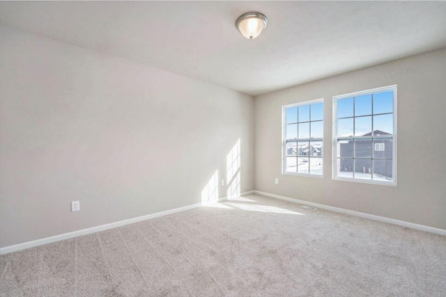 empty room featuring light colored carpet