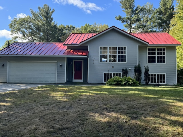 view of front of house with a front yard and a garage