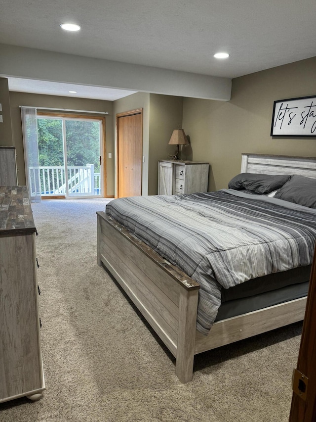 carpeted bedroom with a closet and access to exterior