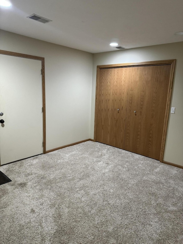 unfurnished bedroom with carpet floors and a closet