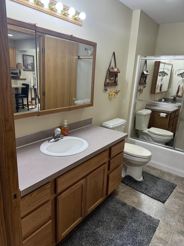 full bathroom featuring toilet, enclosed tub / shower combo, and vanity