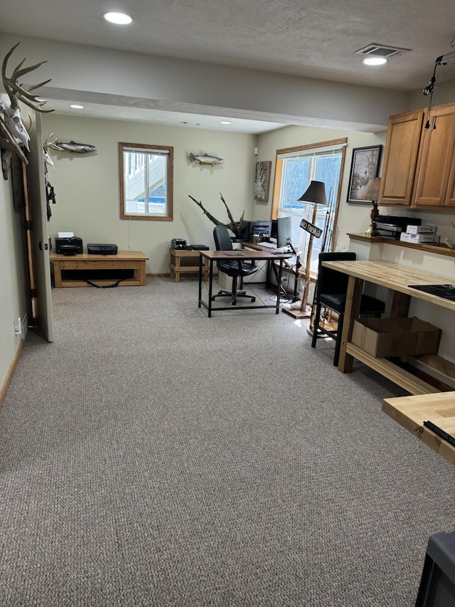 home office with a textured ceiling and carpet floors