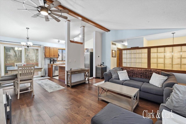 living room featuring a textured ceiling, lofted ceiling with beams, dark wood-type flooring, and ceiling fan with notable chandelier