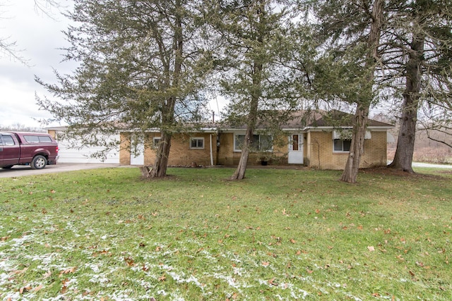 ranch-style house with a garage and a front lawn