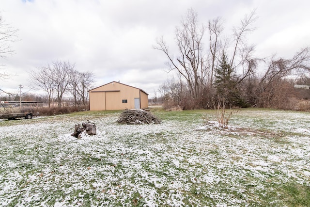 yard layered in snow featuring an outbuilding