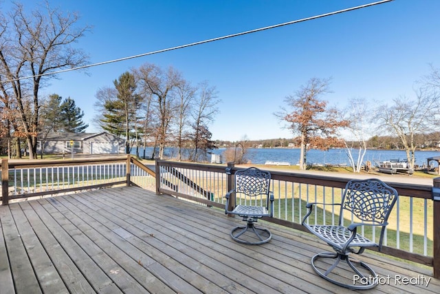 wooden deck featuring a yard and a water view