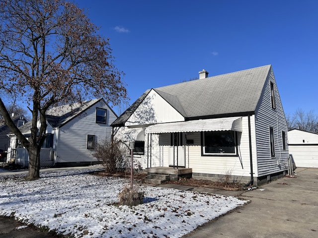 view of front facade with an outbuilding and a garage