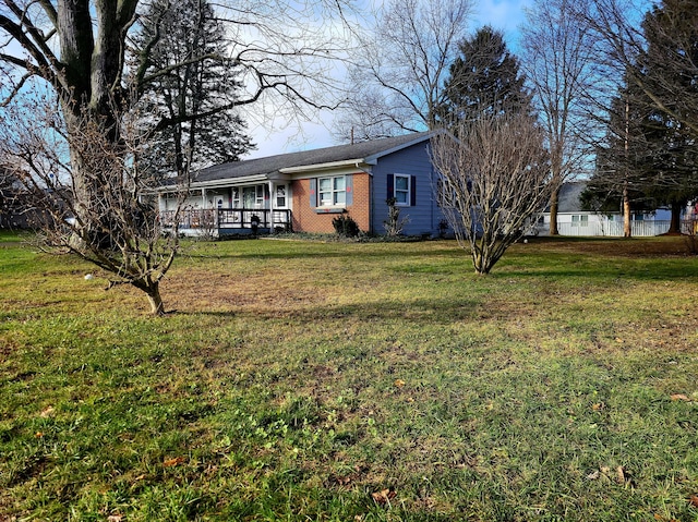 exterior space with a front lawn and a wooden deck