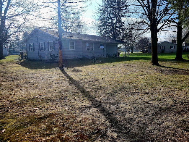 view of side of home featuring a yard