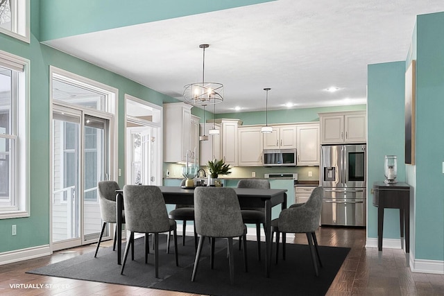 dining room with a notable chandelier and dark hardwood / wood-style flooring