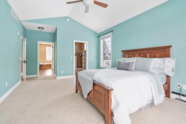 carpeted bedroom featuring a walk in closet, ceiling fan, a closet, and lofted ceiling