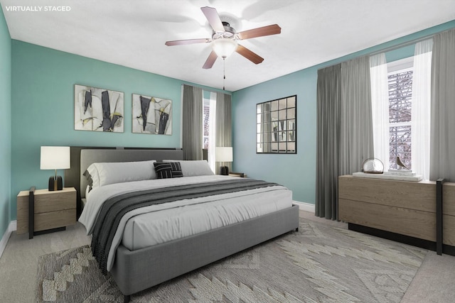 bedroom with ceiling fan, light carpet, and multiple windows