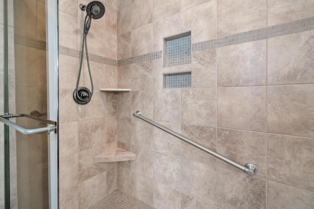 bathroom with a shower with shower door