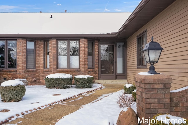 view of snow covered property entrance