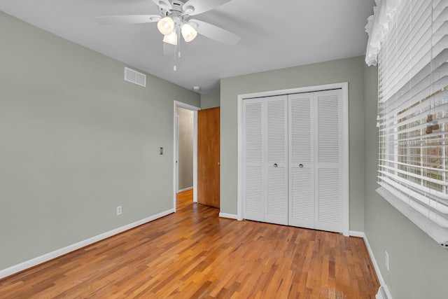 unfurnished bedroom with ceiling fan, a closet, and light hardwood / wood-style flooring