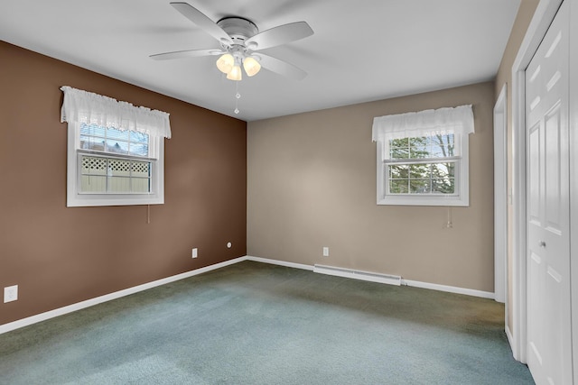 unfurnished bedroom featuring dark colored carpet, a closet, a baseboard radiator, and ceiling fan