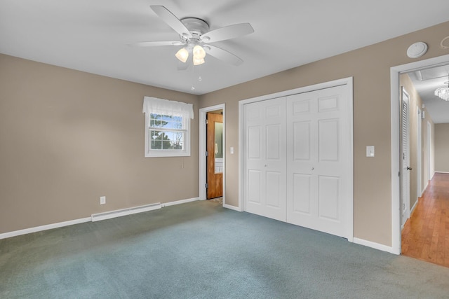 unfurnished bedroom with carpet flooring, a closet, ceiling fan, and a baseboard heating unit