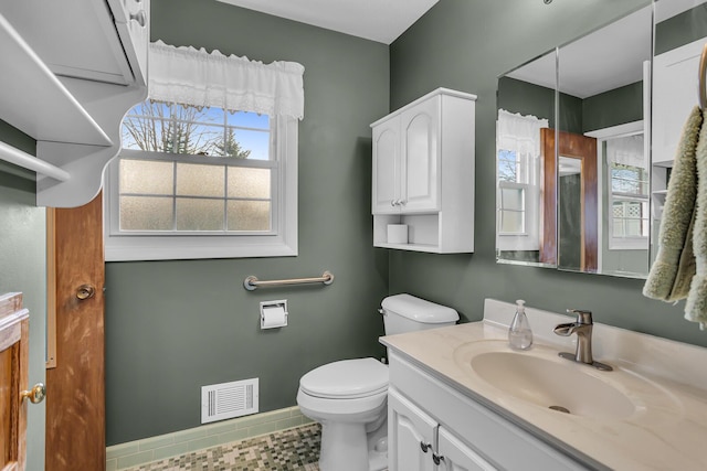 bathroom with tile patterned flooring, vanity, and toilet