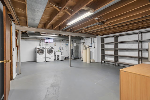 basement with separate washer and dryer and sink