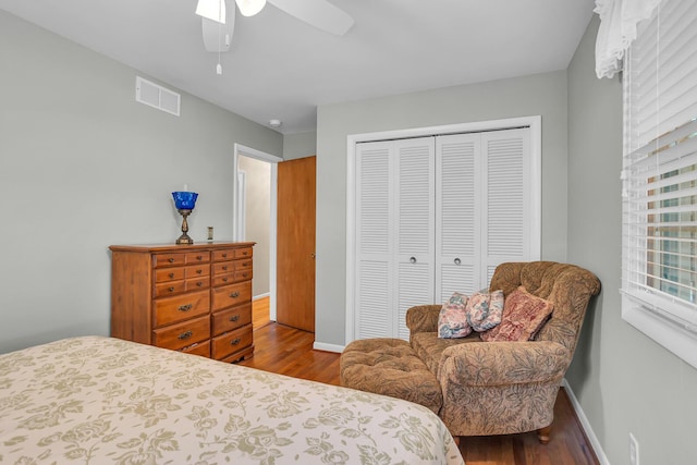 bedroom with hardwood / wood-style flooring, a closet, and ceiling fan