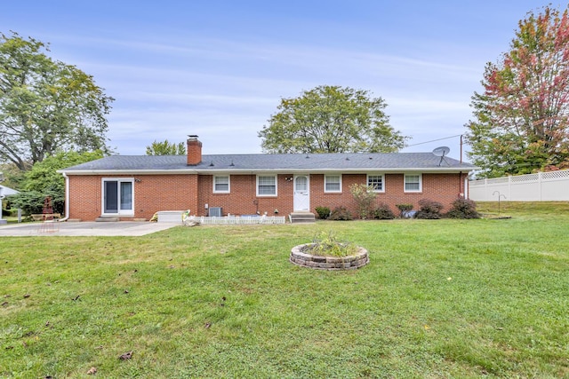 rear view of property featuring a yard and a patio