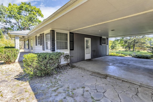 entrance to property featuring a carport