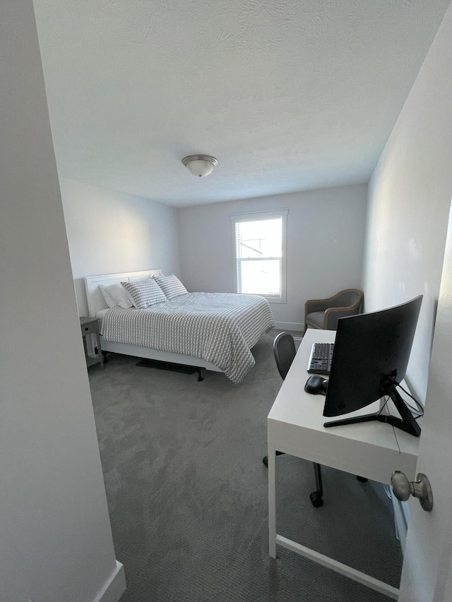 carpeted bedroom with a textured ceiling