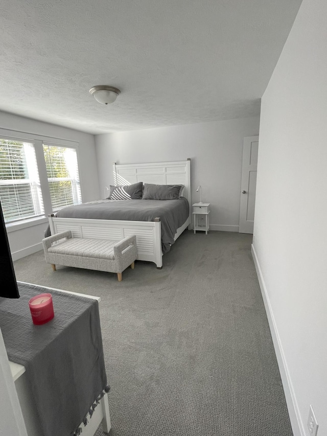 carpeted bedroom featuring a textured ceiling