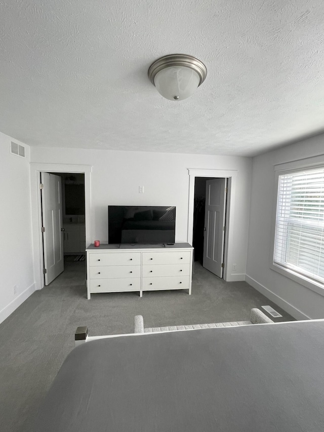 unfurnished bedroom featuring carpet floors and a textured ceiling