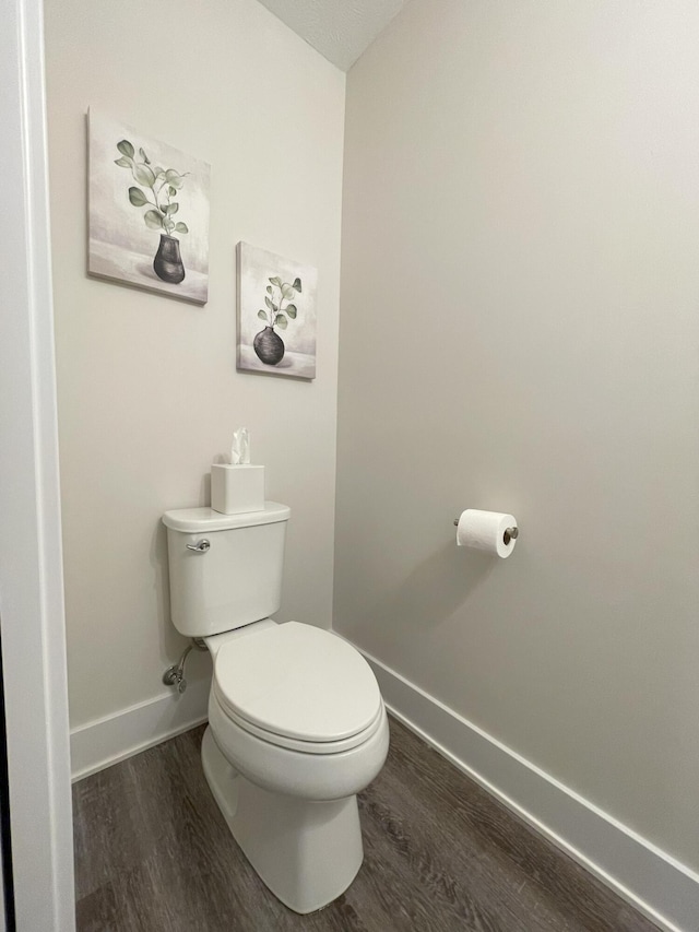 bathroom featuring hardwood / wood-style floors and toilet